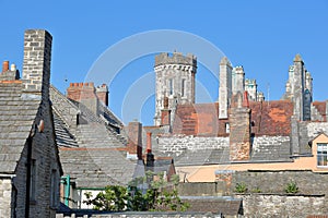 Close-up on flagstone roofs with the Victorian building Purbeck House Hotel in the background, Swanage