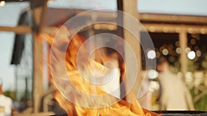 A close-up of the flame of a fire or bonfire that is burning at a backyard party