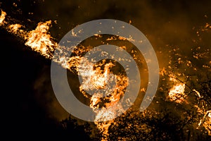 Close up Flames and Embers at Night Twist into Tornado Shape During California Fire