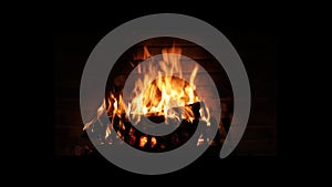 Close-up, flames from the fireplace fire. The logs are burning, sparks are flying. Meditation by the fire
