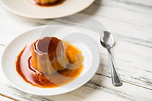 Close up of a flan creme caramel pudding with mint, a custard dessert.