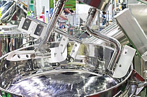 Close up flat beater of large blender or food mixer machine for bulk processing to mix heterogeneous to homogeneous in industrial