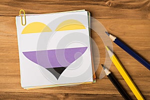 Close up flat lay photo of stack of notice paper office clip drawn heart with white yellow purple black colors and multicolored