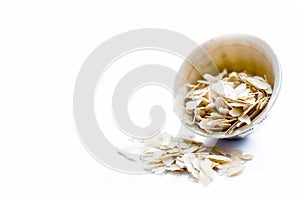 Close up of Flattened rice or beaten rice or Phoa or pava in a bowl isolated on white. photo