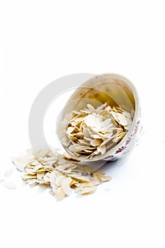 Close up of Flattened rice or beaten rice or Phoa or pava in a bowl isolated on white. photo