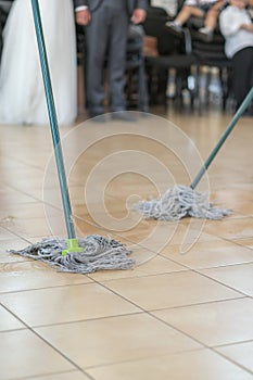 Close up of floor cleaning action with wiper. Cleaning and cleanliness concept. selected focus. vertical photo