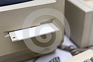 Close up of floppy disk insert into the drive A of the old computer