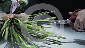 Close up of a florist cutting flower branches with scissors