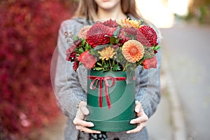 Close-up flower-box in woman hands as a gift concept for wedding, birthday, event, celebration, flowers delivery