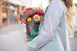 Close-up flower-box in woman hands as a gift concept for wedding, birthday, event, celebration, flowers delivery