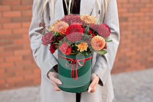 Close-up flower-box in woman hands as a gift concept for wedding, birthday, event, celebration, flowers delivery