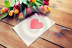 Close up of flowers and greeting card with heart