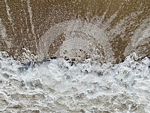 close-up of flowing water, rapid water splashes of an white water river or stream, bubbly water