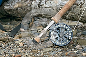 Close up of fly fishing rod and reel on riverbank