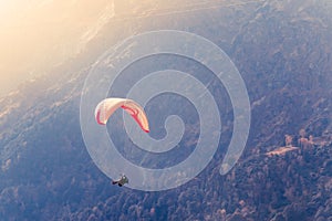 Close up of a Flying colorful parachute paragliding on beautiful mountain background. Solang Nullah, Kullu District, Manali Tehsil