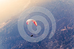 Close up of a Flying colorful parachute paragliding on beautiful mountain background. Solang Nullah, Kullu District, Manali Tehsil