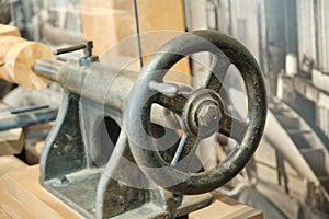 A close-up of the flywheel of an industrial steam engine