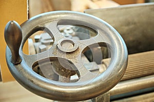 A close-up of the flywheel of an industrial steam engine