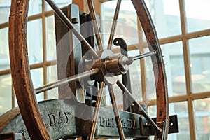 A close-up of the flywheel of an industrial steam engine.