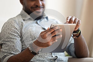 Close up focus of african male hands holding tablet computer