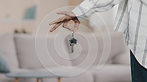 Close-up focus on apartment keys in hand of unrecognizable african american woman homeowner buying house mortgage bank