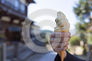 Close up focus of female hand holding melting delicious ice cream or soft cream gelato in japan