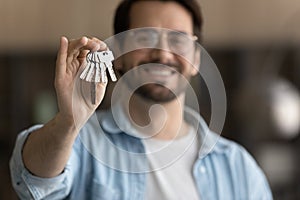 Close up focus on keys in excited man hand