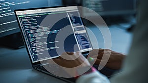 Close-up Focus on Person's Hands Typing on the Desktop Computer Keyboard. Screens Show Coding
