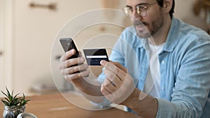 Close up focus on plastic credit banking card in male hands.