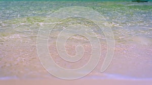 Close up focused sandy beach blurred sky sunlight Hawaii. Beach sand close up white foamy nature sunny summer exotic shore