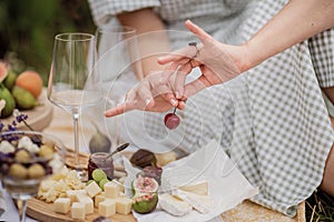 Close-up of food on the open diaphragm of food Summer season.Lavender fields. The girl & x27;s hands holding cherries