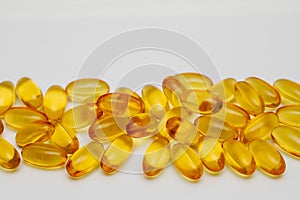 Close up of food supplement oil filled capsules suitable for: omega 3, omega 6, vitamin A, vitamin D, vitamin E