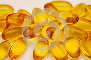 Close up of food supplement oil filled capsules suitable for: omega 3, omega 6, vitamin A, vitamin D, vitamin E