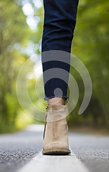 Close up of a foot and elegant boot - forest background