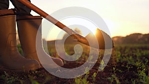 Close-up foot of farmer, worker man digging soil