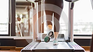 Close up foot sneakers Fitness girl running on track treadmill, Fat woman with muscular legs in exercise gym