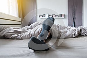 Close up of foot with socks,Feet and stretch lazily on the bed