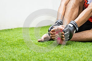 Close up on foot sole Injury. The man use hands hold on his foot sole while running in the park. space for text or design.