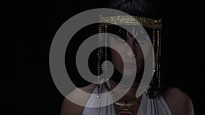 Close up footage of the look of Cleopatra, wearing white dress and jewelry