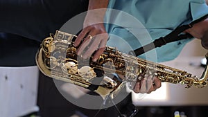 Close up footage of Musician saxophonist plays music on his instrument.