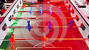 Close up footage of table football figures spin and hit the ball