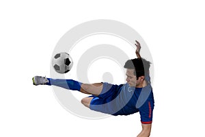 Close up of a football action scene with soccer player kicks a soccerball