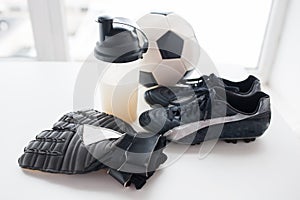 Close up of football, boots, gloves and bottle