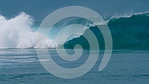 CLOSE UP: Forceful barrel wave splashes ocean water around the coast of Tahiti.