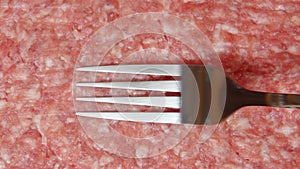 CLOSE UP: Fork in a cook hand is moving on a fresh forcemeat