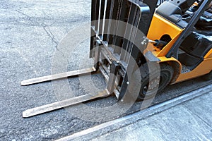 Close up of fork lift blades on an urban city street