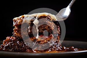 close-up of fork into a piece of moussaka