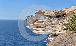 close up on formation cliff in limestone with sea background