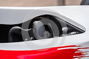 Close-up of Formula 1 car underside, highlighting exhaust system and suspension assembly components Artificial lighting from above