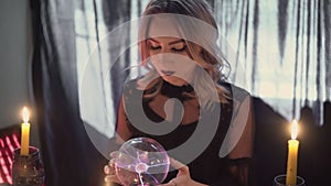 Close up of fortune teller performing ritual and crystal ball foreseeing future